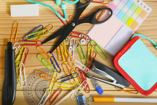 Assorted office stationery supplies on a wooden desk